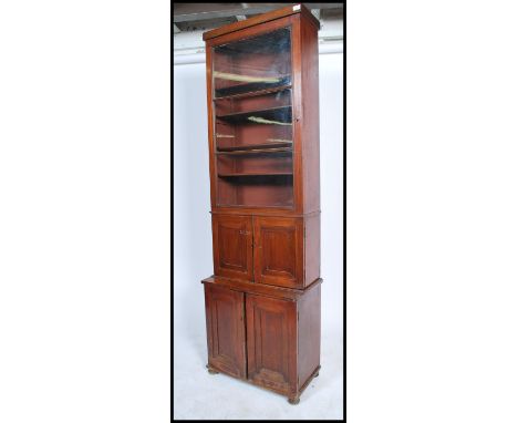 A 19th century mahogany bookcase cupboard of slim proportions having an arrangement of glazed and panel doors.&nbsp;Measures: