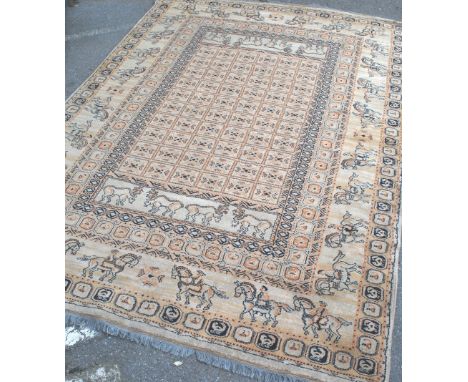 A believed mid century large Pazyryk rug depicting men on horseback and antelopes in the border surrounding a central field c