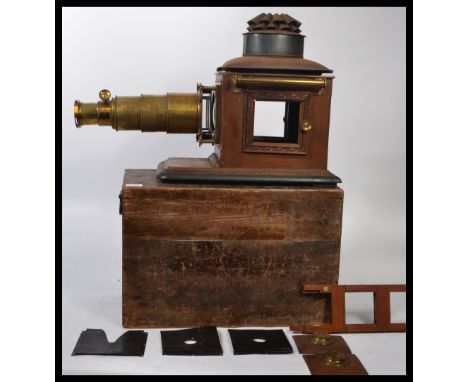 A vintage 20th century magic lantern slide viewer of wooden and brass construction set within a wooden case. Measures 42 cm h