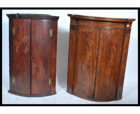 2 19th century Georgian flame mahogany bow fronted corner cabinets. One larger with inlaid marquetry detailing, each with ful