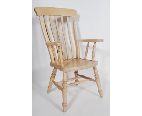 A Victorian style 20th century light beech wood windsor armchair - chair. Raised on turned legs united by stretcherss with a 