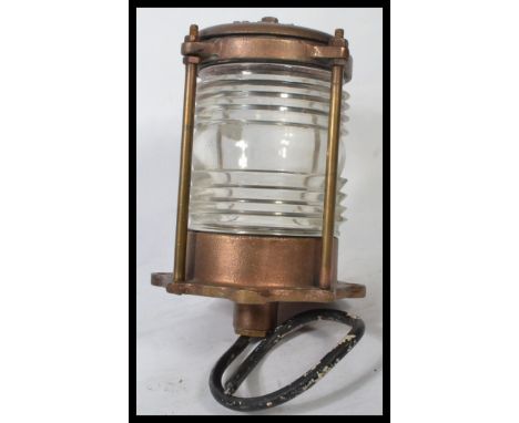 A vintage 20th century brass and wire caged mast lamp having clear glass lining, Stamped L.L.R. Co. Measures 34 cm high.