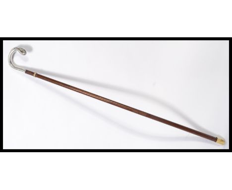 A vintage early 20th century silver hallmarked walking stick cane having a tapering wooden shaft. The handle in the form of a