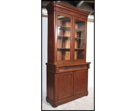 A 19th century mahogany bookcase cabinet having glazed doors to the top with adjustable shelves to the inner above a single d