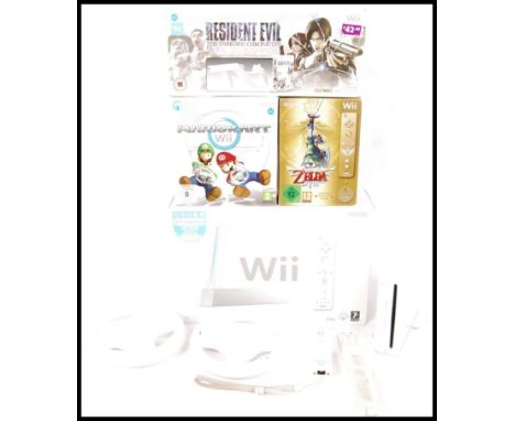 A boxed Nintendo Wii games console, some contents missing, along with loose Wii, Resident Evil The Darkside Chronicles gun, T