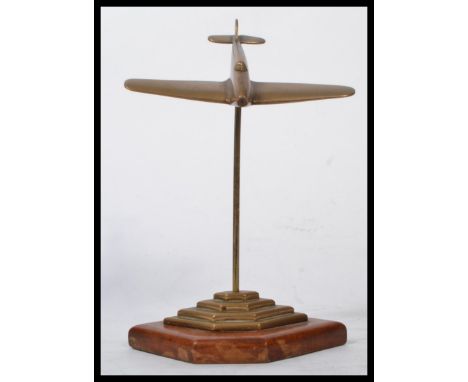 A vintage 20th century World War Two second World War WW2 trench art style brass model of a Spitfire aeroplane in a diving po