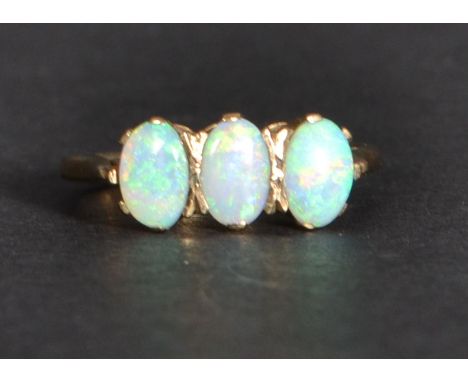 A 9ct gold opal three stone ring. SIze k Weighs 1.9 grams.