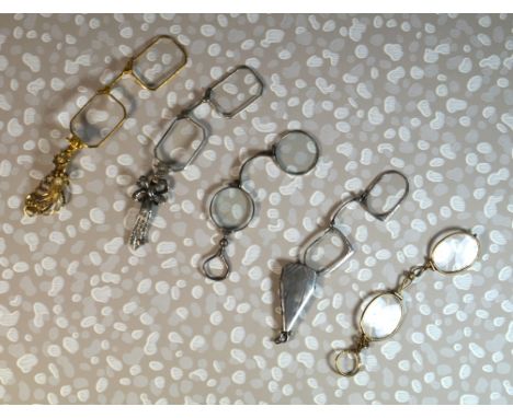 A collection of vintage lorgnettes 
To include a three white metal examples, one with marcasite ribbon handle, one with engin