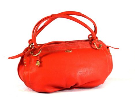 A Celine coral leather handbag 
The textured leather bag, with central zip and applied with brasswork ring fittings, supporte