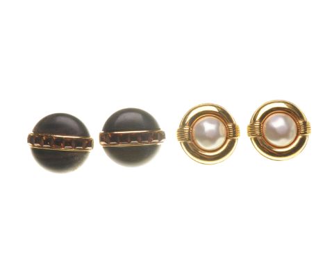 Chanel: A pair of ear clips
Of circular form, set with faux pearls, to a gold tone surround, both signed Chanel 23 2623, diam