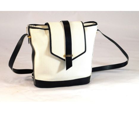 A Vintage Yves Saint Laurent tote handbag 
The white textured bucket shaped bag, with navy leather trim and shoulder strap, a