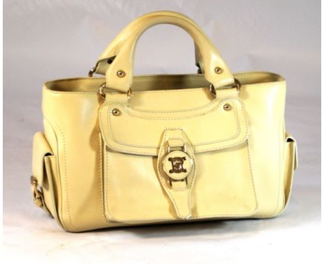 A Celine 'Boogie' bag 
The cream leather, with twin side pockets, upper zip detail and and front pocket, with exposed stitchi