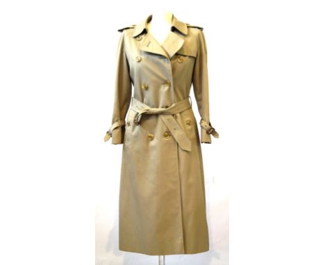 A classic Burberry ladies Balmoral trench coat
The classic design with ten buttons to the front, belt and classic tartan inte