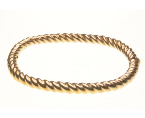 A 9ct gold rope twist bangle
Of shaped rectangular form, half hinged, stamped 9K, length 7.5cm 