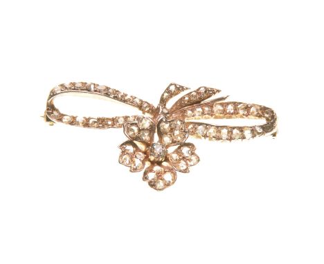 A Victorian diamond set floral spray brooch
Set with rose-cut diamonds throughout, the flower with an old brilliant-cut diamo