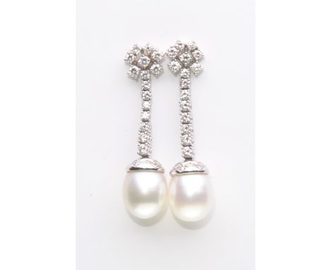 A pair of diamond and cultured pearl pair of ear pendants
Each suspending a cultured pearl, approx. 10.64 x 10.88mm and 10.67