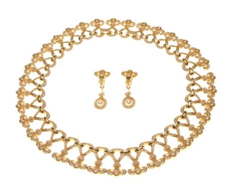 Christian Dior: A gold tone and rhinestone set necklace and drop ear clip suite
Composed of individual articulated panels, ea