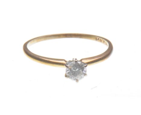 A diamond solitaire ring  
Centering a round brilliant-cut diamond, six claw set, shank stamped 14K, diamond weight approxima