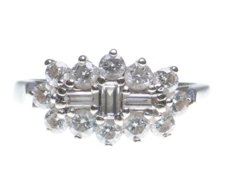 A diamond cluster ring
With three baguette-cut diamonds centrally set, to a round brilliant-cut surround, mounted in 18ct whi