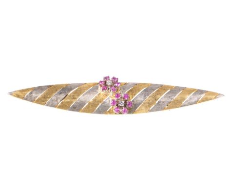 An Italian ruby and diamond brooch
Of navette form, the bi-coloured gold brooch, with alternating white a yellow gold diagona