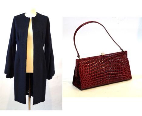 An Amanda Wakeley wool coat 
Consisting of Alpaca and sheep's wool navy blue coat, with no collar and puffed sleeves, approx.
