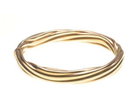 A 9ct gold strand bangle
Of oval form, half hinged, stamped 9K, length 7.3cm 
