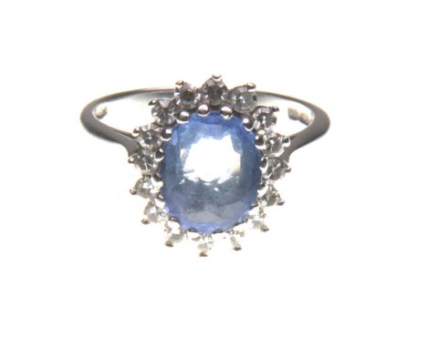 A sapphire and diamond cluster ring
The light coloured oval mixed-cut sapphire, to a single-cut diamond surround, mounted on 