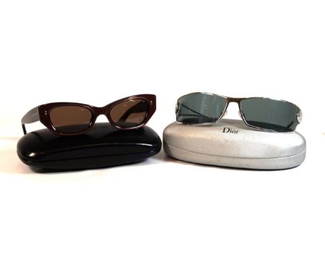 Two pairs of designer sunglasses 
To include a pair of J'Adore Christian Dior silvered framed wrap around glasses, with origi