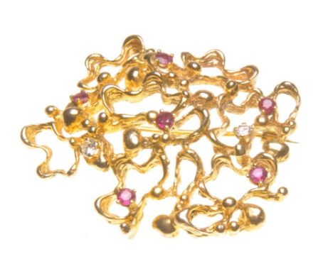A ruby and diamond abstract brooch
Set with round brilliant-cut diamonds and circular-cut rubies, to a 9ct gold openwork moun
