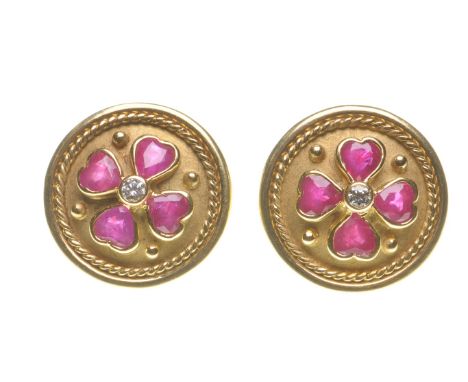 A pair of ruby and diamond ear studs
Of circular form, the mixed-cut rubies set to form a shamrock, centering a round brillia