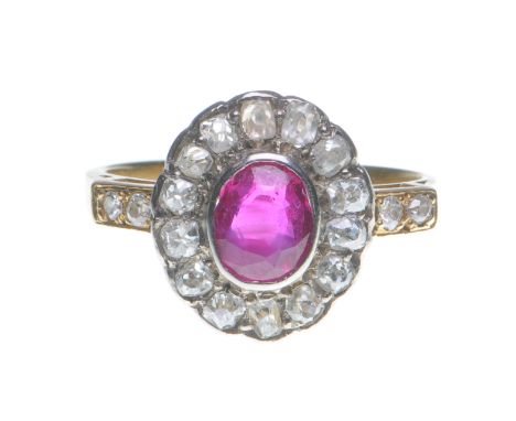 A ruby and diamond cluster ring
The oval mixed-cut ruby to an old-cut diamond surround, flanked by diamond shoulders, shank s