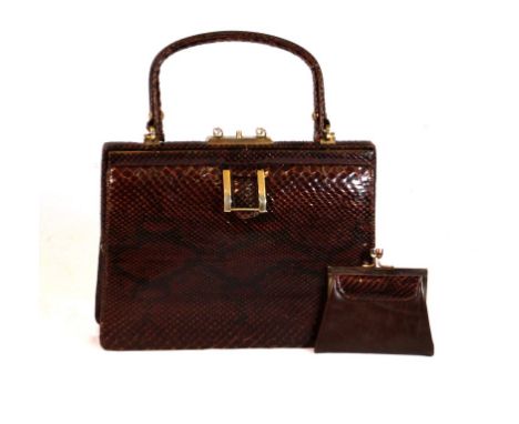A Vintage snakeskin handbag
The tapered square section bag, applied with dark variegated brown skin, with single loop handle 