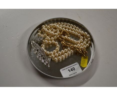 An Art Deco style costume bar brooch; together with a simulated pearl necklace; and a bracelet