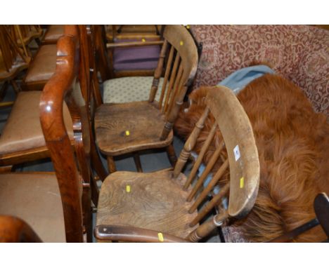 A pair of elm seated stick back kitchen chairs