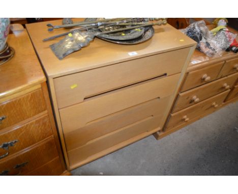 A light oak veneered chest fitted four long drawers