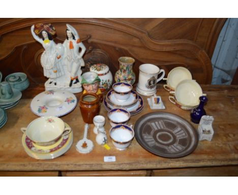 A Staffordshire flat back figure group; together with a Poole pottery dish; a commemorative tankard etc. 