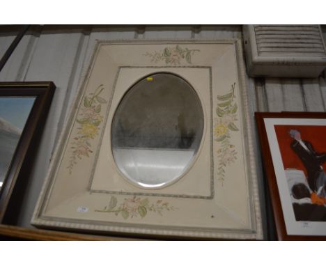 A large floral painted oval mirror 