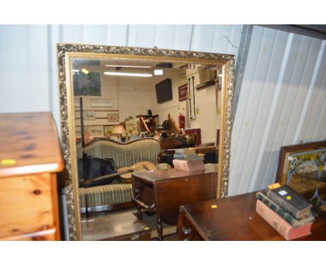 A large gilt framed and bevel edged mirror 