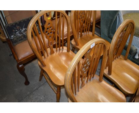 A set of four stick and wheel back kitchen chairs 