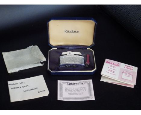 A cased Ronson Milady pocket lighter with original paperwork and brush.