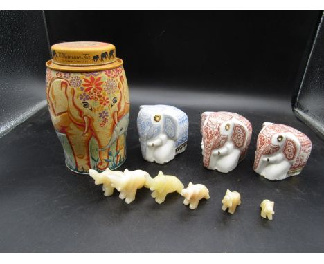 3 ceramic elephant tea cannisters, a tea tin with elephant decoration and a herd of mini onyx elephants&nbsp;