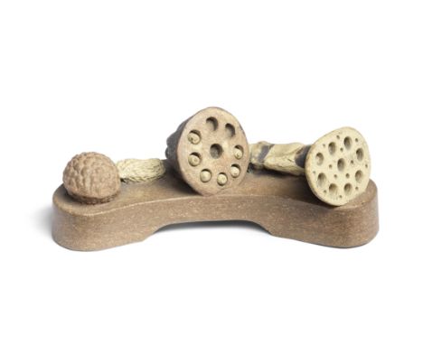 AN YIXING STONEWARE 'LOTUS POD' BRUSHRESTImpressed Chen Mingyuan seal mark, Qing DynastyOf elegant curved form and raised on 