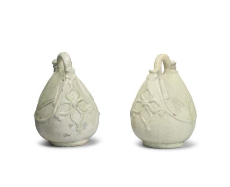 A PAIR OF GREEN-GLAZED FLASK-SHAPED EWERSLiao DynastyEach naturalistically moulded with generously rounded sides tapering to 
