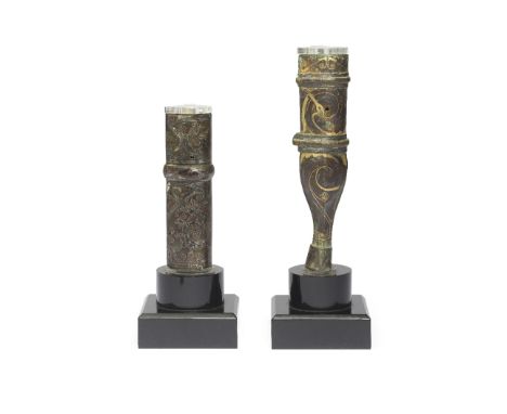 TWO SILVER AND GOLD-INLAID BRONZE FITTINGSWarring States PeriodThe silver-inlaid bronze chariot fitting of pointed oval secti