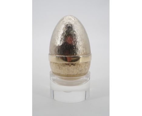 Stuart Devlin An Elizabeth II silver-gilt novelty 'Surprise Egg' "Floral Festival", planished and brushed, opening to reveal 