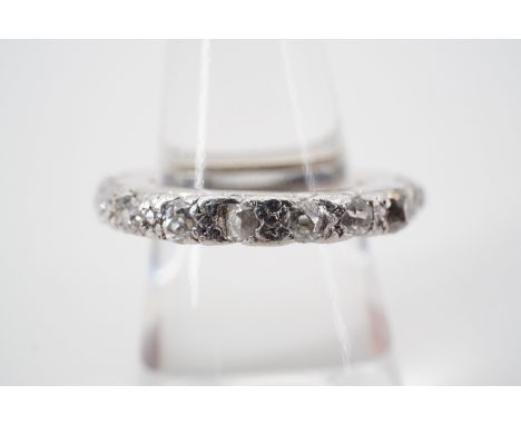 A contemporary diamond and platinum eternity ring, of wheel form, the face illusion set with various cuts of diamond, predomi