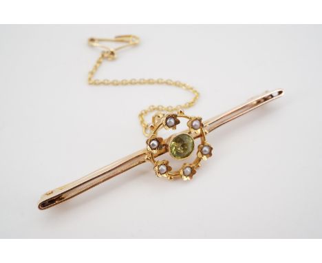An antique high-carat yellow-metal, peridot and split-seed pearl bar brooch, with central round-cut and millegrain set perido