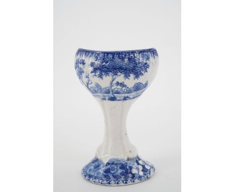 A 19th Century Spode pottery blue and white transfer printed eye bath, one face decorated with a tower house, the other a rur