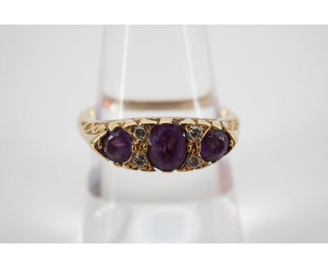 An 18ct gold, diamond and amethyst dress ring, the lenticular face sunken set with an oval-cut amethyst of approximately .2ct