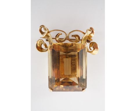 A vintage high carat yellow-metal and citrine brooch, the emerald cut citrine of approximately 24 x 19 mm, claw set beneath a